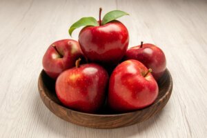 front view fresh red apples ripe mellow fruits white desk fruit color tree fresh plant red